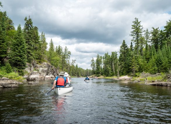 Paddling canoes on the lake in Nopiming